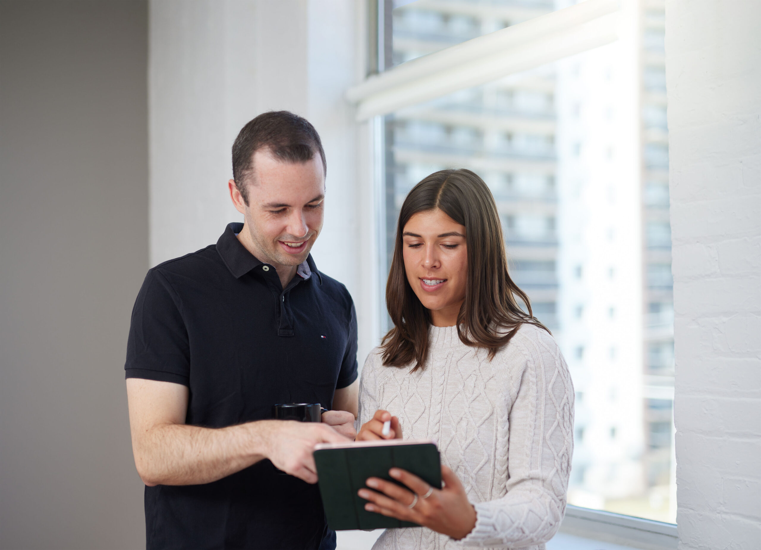 Two Isaac employees reading a report