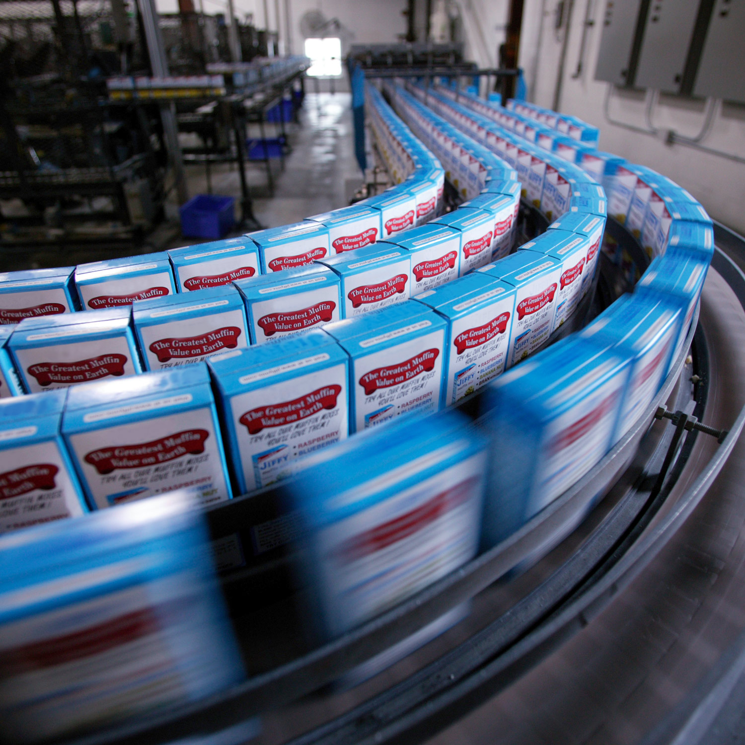 Factory conveyor belt moving boxes of jiffy muffin mix